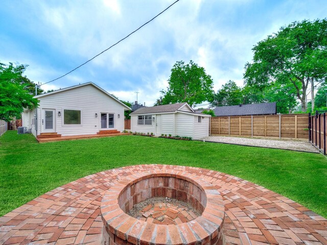 209 S Marlborough Ave, Dallas, TX 75208 - back of house with a fire pit, an outdoor structure, central AC unit, and entry steps