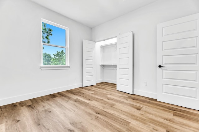 4017 Carl St, Dallas, TX 75210 - unfurnished bedroom with baseboards, light wood finished floors, and a closet