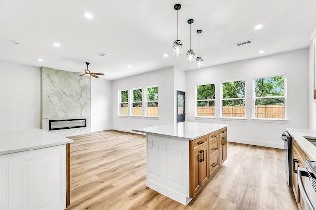 4017 Carl St, Dallas, TX 75210 - kitchen with ceiling fan, light wood-type flooring, recessed lighting, light countertops, and decorative light fixtures