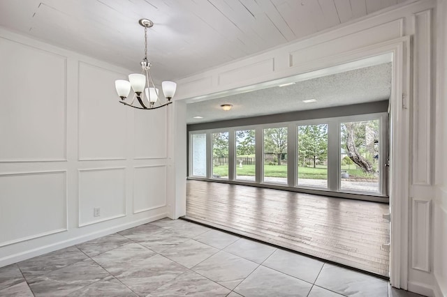 8 Canyon Ridge Dr, Fate, TX 75087 - unfurnished dining area featuring a decorative wall and a chandelier