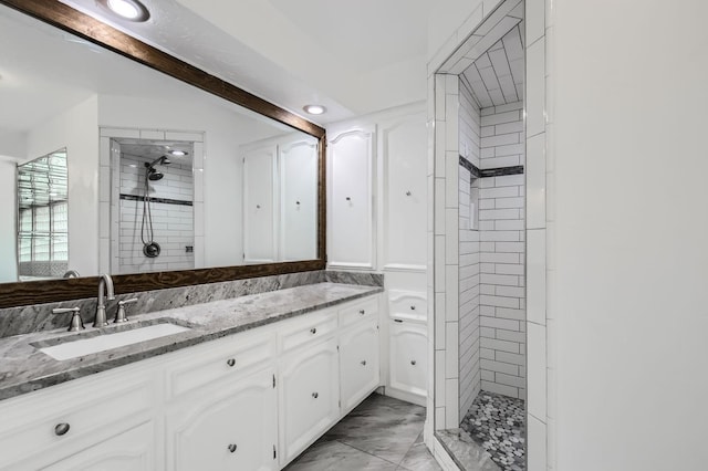 8 Canyon Ridge Dr, Fate, TX 75087 - full bathroom featuring a tile shower, vanity, marble look tile flooring, and recessed lighting