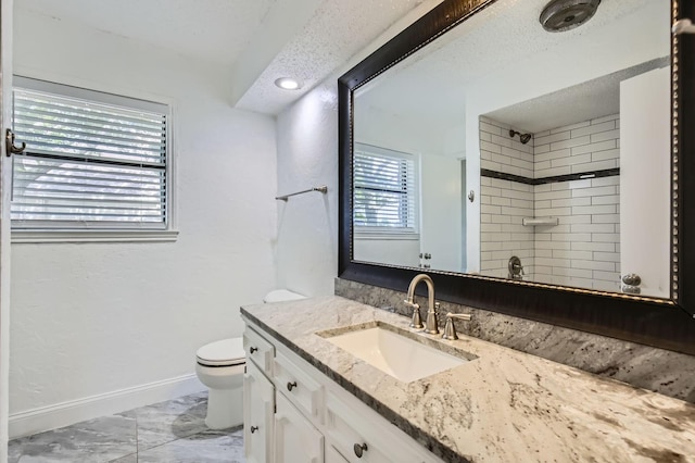 8 Canyon Ridge Dr, Fate, TX 75087 - full bath with toilet, marble look tiles, vanity, a shower, and baseboards