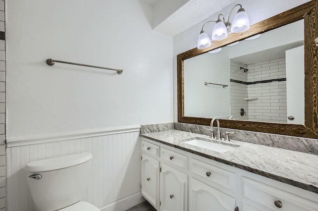 8 Canyon Ridge Dr, Fate, TX 75087 - full bathroom with vanity, toilet, wainscoting, and a shower