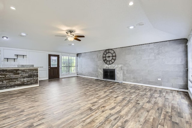 8 Canyon Ridge Dr, Fate, TX 75087 - unfurnished living room featuring a ceiling fan, wood finished floors, baseboards, a high end fireplace, and recessed lighting