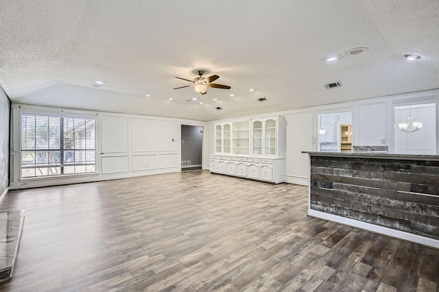 8 Canyon Ridge Dr, Fate, TX 75087 - unfurnished living room featuring ceiling fan, wood finished floors, a textured ceiling, recessed lighting, and vaulted ceiling