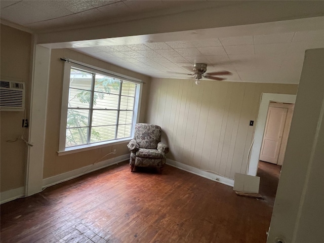 920 Anna St, Denton, TX 76201 - unfurnished room featuring wood-type flooring, baseboards, a ceiling fan, a wall unit AC, and wooden walls