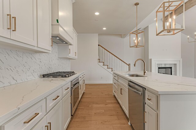 14448 Walsh, Aledo, TX 76008 - kitchen with appliances with stainless steel finishes, a sink, light wood-style floors, tasteful backsplash, and recessed lighting