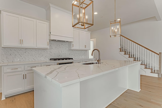 14448 Walsh, Aledo, TX 76008 - kitchen with light wood-type flooring, tasteful backsplash, a sink, white cabinetry, and recessed lighting