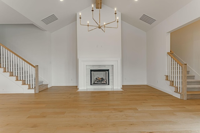 14448 Walsh, Aledo, TX 76008 - unfurnished living room featuring stairs, high vaulted ceiling, wood finished floors, a chandelier, and baseboards