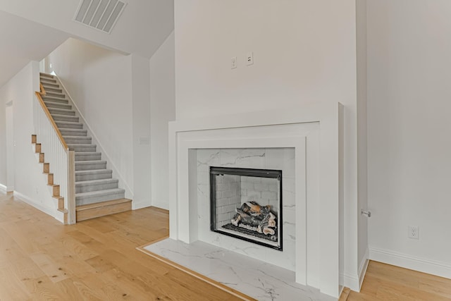 14448 Walsh, Aledo, TX 76008 - detailed view of wood finished floors, baseboards, and a high end fireplace