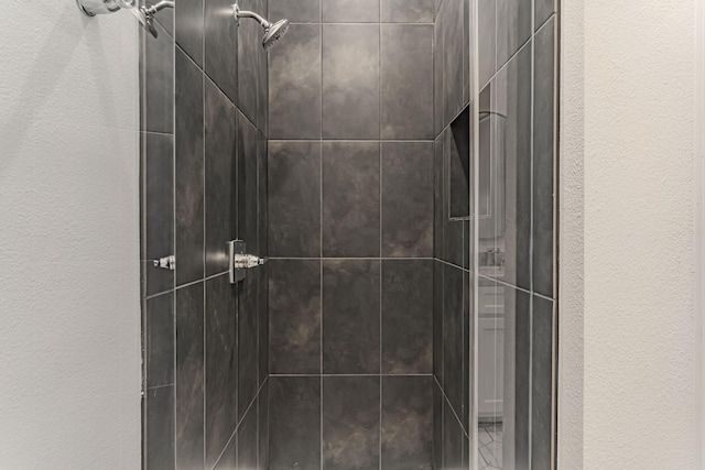 14448 Walsh, Aledo, TX 76008 - bathroom featuring a tile shower and a textured wall