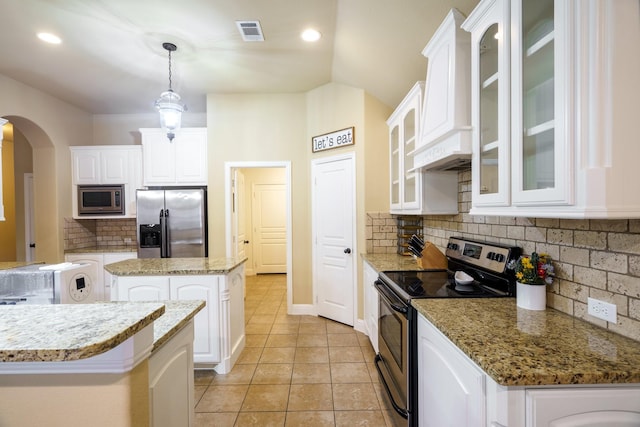 5204 Agave Way, Fort Worth, TX 76126 - kitchen featuring appliances with stainless steel finishes, arched walkways, light tile patterned floors, a kitchen island, and white cabinets