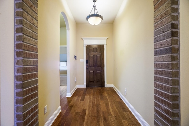 5204 Agave Way, Fort Worth, TX 76126 - entryway featuring arched walkways, dark wood-style floors, and baseboards
