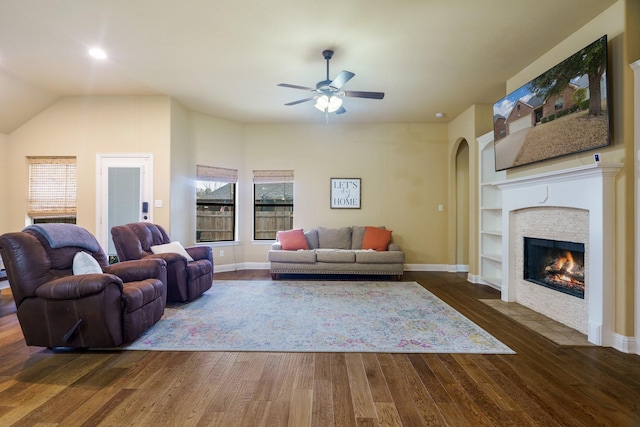 5204 Agave Way, Fort Worth, TX 76126 - living area with arched walkways, a ceiling fan, wood finished floors, a fireplace, and baseboards