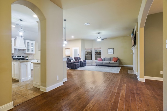 5204 Agave Way, Fort Worth, TX 76126 - living area featuring wood finished floors, arched walkways, a ceiling fan, baseboards, and recessed lighting