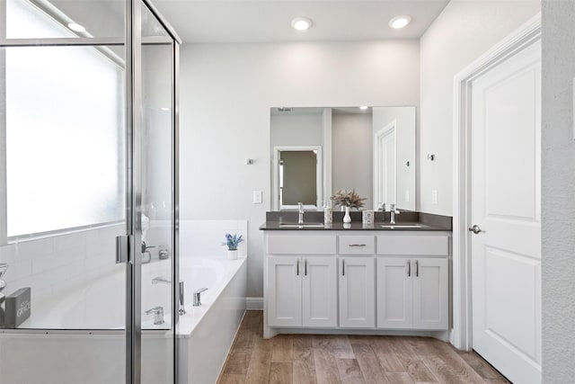11413 Leeson St, Fort Worth, TX 76052 - full bath featuring a garden tub, double vanity, a stall shower, wood finished floors, and recessed lighting