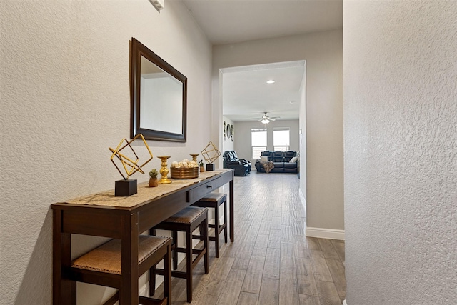 11413 Leeson St, Fort Worth, TX 76052 - hallway with a textured wall, wood finished floors, baseboards, and recessed lighting