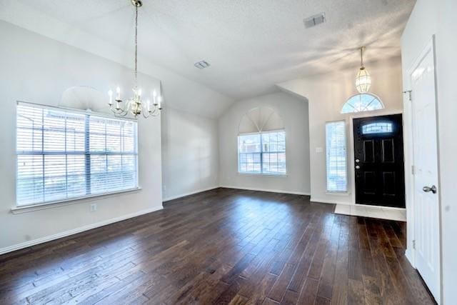 833 Tablerock Way, Lewisville, TX 75077 - foyer entrance with a chandelier, dark wood finished floors, vaulted ceiling, and baseboards