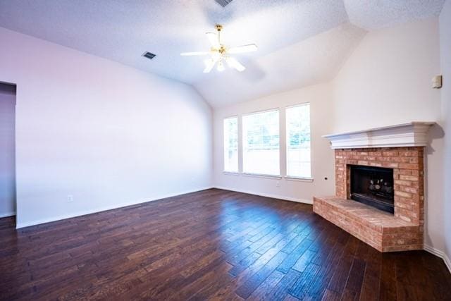 833 Tablerock Way, Lewisville, TX 75077 - unfurnished living room with ceiling fan, vaulted ceiling, hardwood / wood-style floors, a fireplace, and baseboards