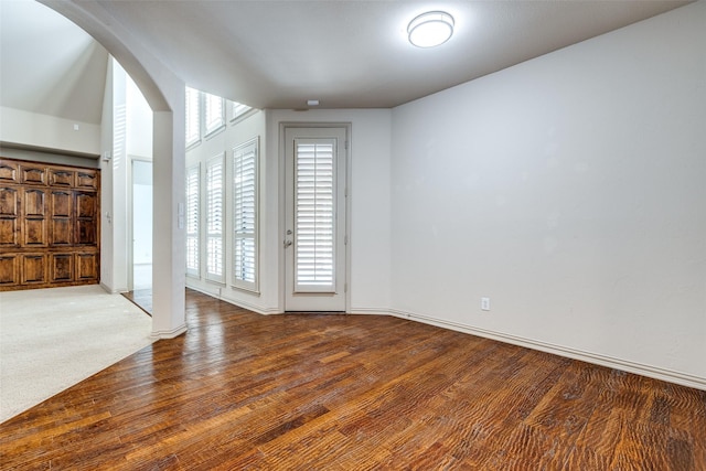 11257 Lamar Ln, Frisco, TX 75033 - unfurnished room with arched walkways, wood finished floors, and baseboards