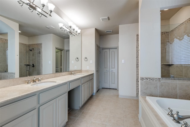 11257 Lamar Ln, Frisco, TX 75033 - bathroom with tile patterned flooring, double vanity, a bath, a tile shower, and baseboards