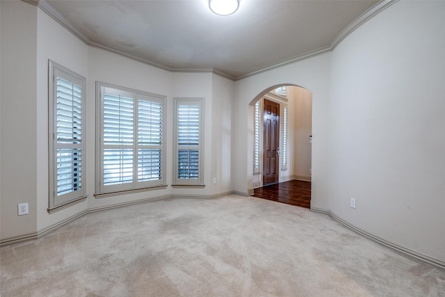 11257 Lamar Ln, Frisco, TX 75033 - carpeted spare room with arched walkways, crown molding, and baseboards