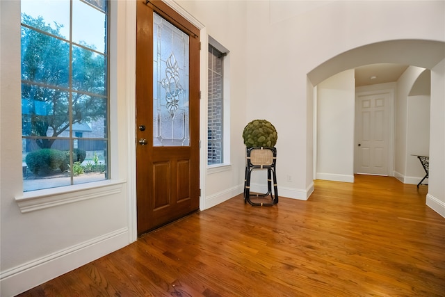 1503 Willingham Dr, Allen, TX 75013 - entrance foyer with arched walkways, wood finished floors, and baseboards
