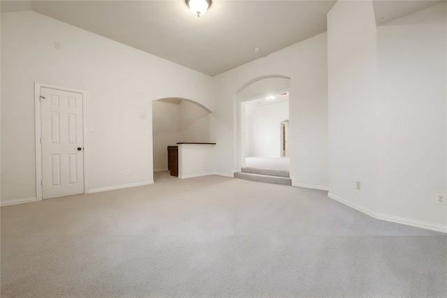 1503 Willingham Dr, Allen, TX 75013 - spare room featuring arched walkways, carpet, baseboards, and lofted ceiling