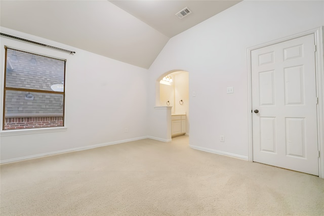 1503 Willingham Dr, Allen, TX 75013 - unfurnished bedroom featuring vaulted ceiling, light colored carpet, baseboards, arched walkways, and connected bathroom