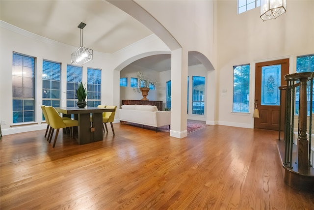 1503 Willingham Dr, Allen, TX 75013 - dining space with a chandelier, ornamental molding, wood finished floors, arched walkways, and baseboards