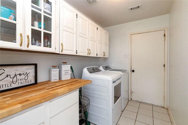 13412 Dove Ranch Rd, Fort Worth, TX 76262 - washroom with cabinet space, separate washer and dryer, light tile patterned floors, and a textured ceiling