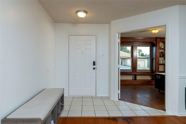 13412 Dove Ranch Rd, Fort Worth, TX 76262 - entryway with light tile patterned flooring, baseboards, and a textured ceiling