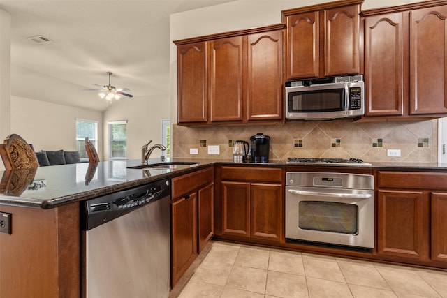 408 Castle St, Desoto, TX 75115 - kitchen featuring appliances with stainless steel finishes, dark stone countertops, backsplash, ceiling fan, and lofted ceiling