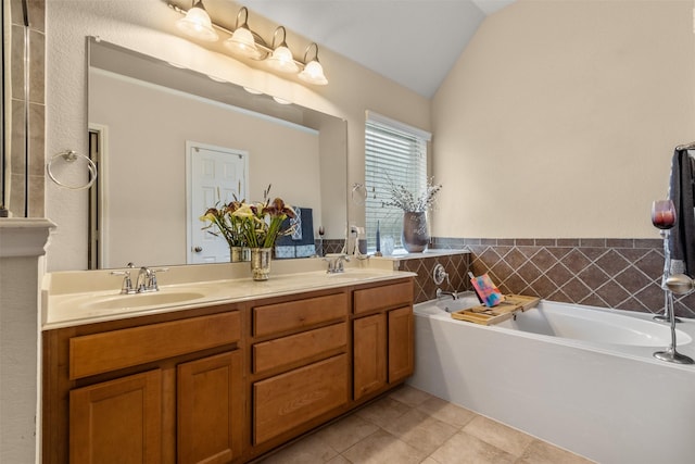 408 Castle St, Desoto, TX 75115 - bathroom featuring tile patterned floors, a bath, double vanity, and vaulted ceiling