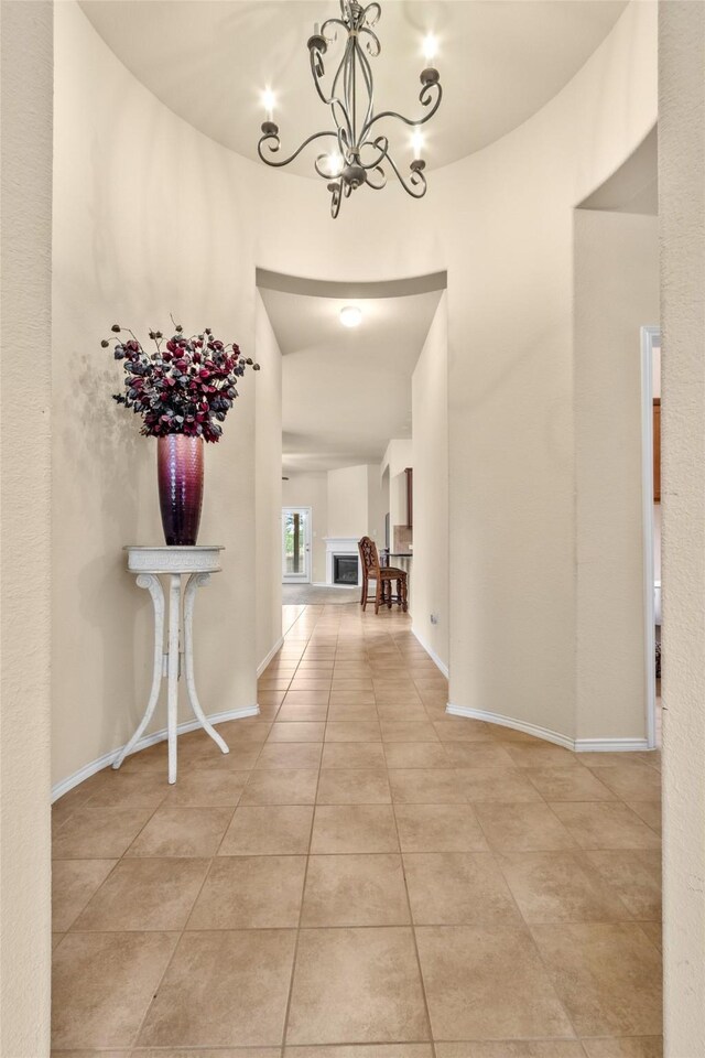 408 Castle St, Desoto, TX 75115 - hallway featuring a chandelier, light tile patterned floors, and baseboards