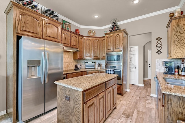 489 Roberts Run, Sherman, TX 75092 - kitchen with stainless steel appliances, backsplash, light stone counters, a kitchen island, and crown molding