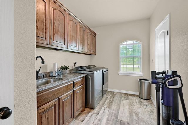 489 Roberts Run, Sherman, TX 75092 - laundry area with independent washer and dryer, cabinet space, light wood-type flooring, and baseboards