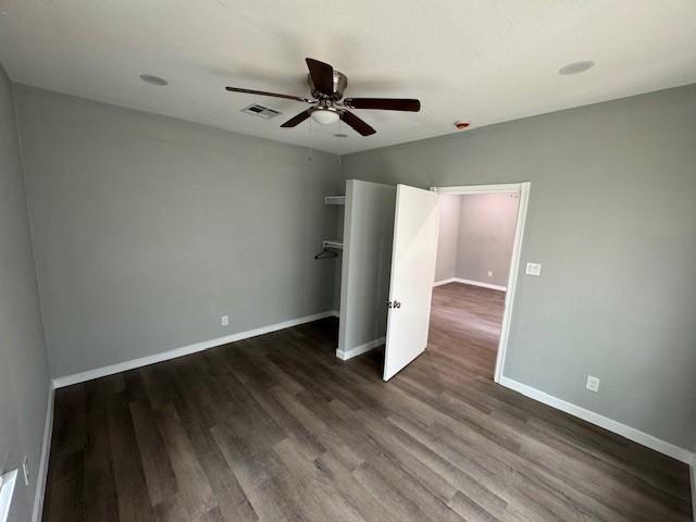 1511 Gurley Ave, Waco, TX 76706 - unfurnished bedroom featuring dark wood-type flooring, baseboards, and ceiling fan