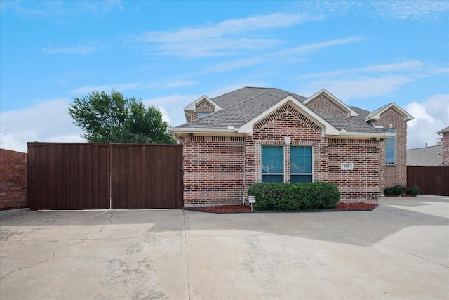 104 Trinity Ct, Coppell, TX 75019 - view of side of home with brick siding and a shingled roof
