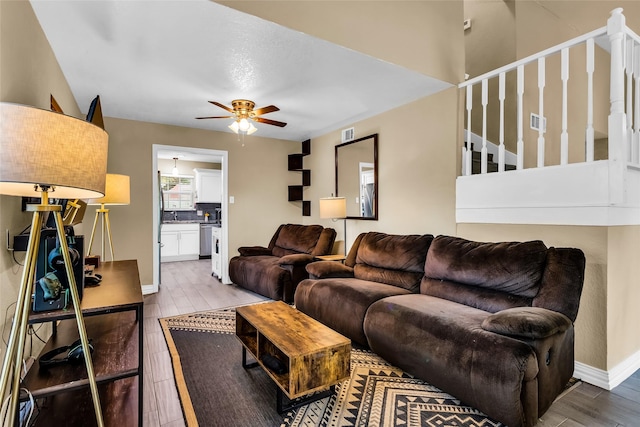 8910 Deerwood Dr, Rowlett, TX 75088 - living area with a ceiling fan, stairs, wood finished floors, and baseboards