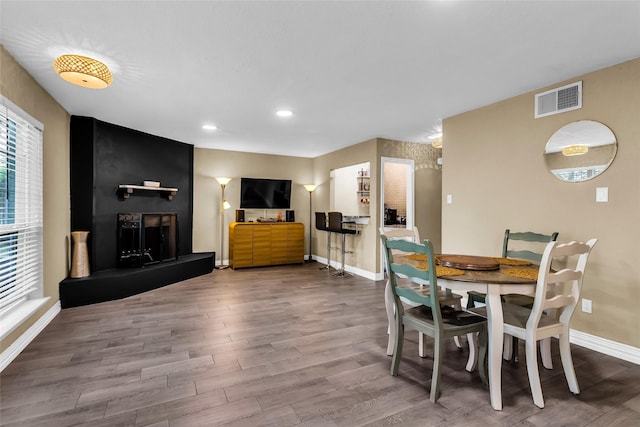 8910 Deerwood Dr, Rowlett, TX 75088 - dining area featuring baseboards, wood finished floors, and recessed lighting