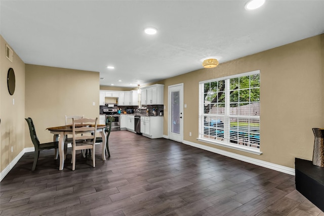 8910 Deerwood Dr, Rowlett, TX 75088 - dining area featuring baseboards, dark wood-type flooring, and recessed lighting