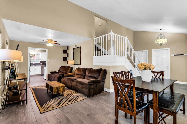 8910 Deerwood Dr, Rowlett, TX 75088 - living room with a chandelier, wood finished floors, stairs, a ceiling fan, and high vaulted ceiling
