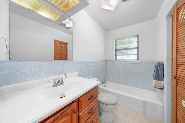 104 W Oak St, Yantis, TX 75497 - bathroom featuring toilet, a garden tub, vanity, tile patterned floors, and tile walls
