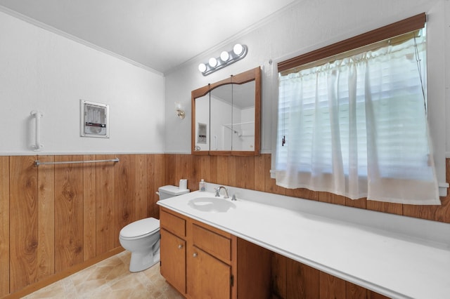 104 W Oak St, Yantis, TX 75497 - bathroom with wooden walls, toilet, ornamental molding, vanity, and a wainscoted wall