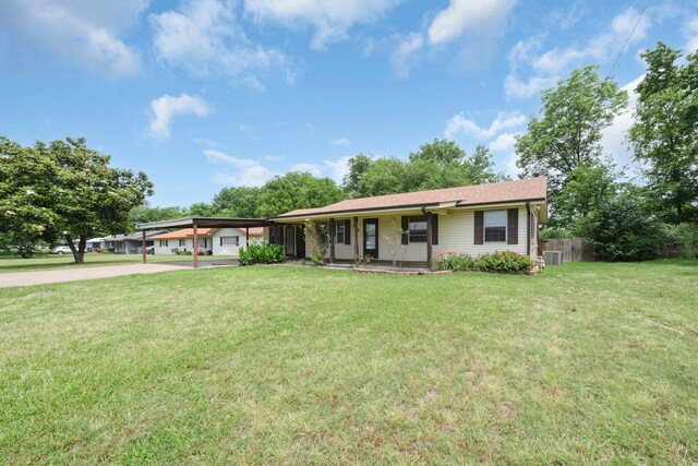 104 W Oak St, Yantis, TX 75497 - single story home with driveway, covered porch, and a carport