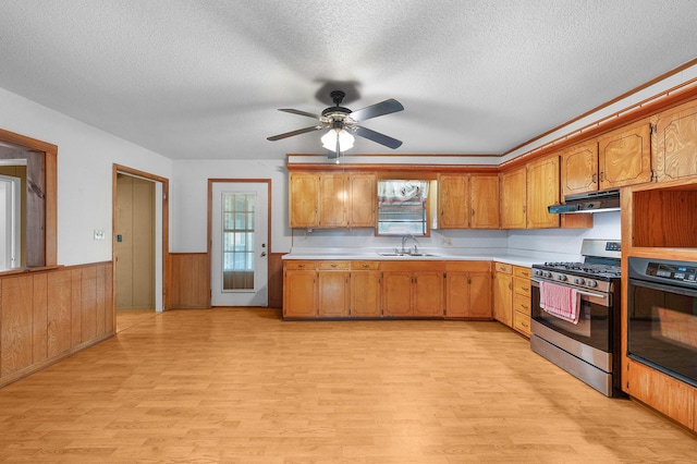 104 W Oak St, Yantis, TX 75497 - kitchen featuring stainless steel gas range, oven, light wood-type flooring, a sink, and a textured ceiling