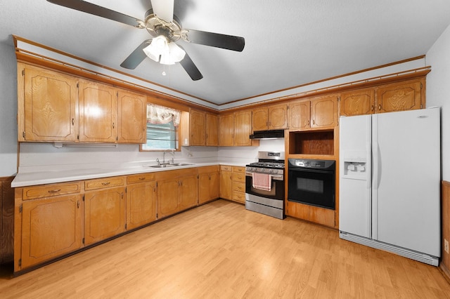 104 W Oak St, Yantis, TX 75497 - kitchen featuring white refrigerator with ice dispenser, gas stove, black oven, a sink, and light wood finished floors