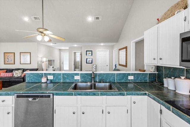 970 Gulfview Dr, Crystal Beach, TX 77650 - kitchen featuring stainless steel appliances, a sink, open floor plan, ceiling fan, and white cabinetry