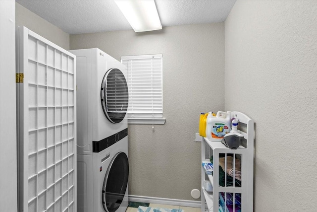 970 Gulfview Dr, Crystal Beach, TX 77650 - washroom featuring estacked washer and dryer and baseboards